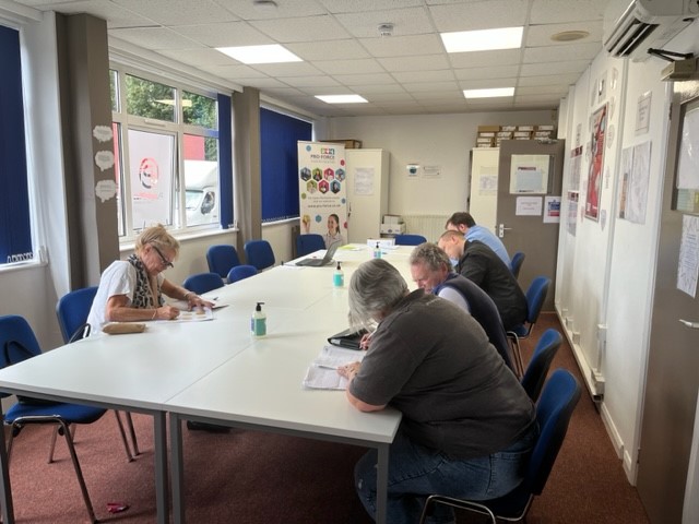 A group of people sitting at a table Description automatically generated